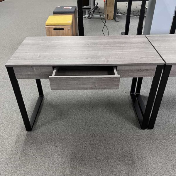 grey laminate desk with black metal rectangle legs and one pencil drawer
