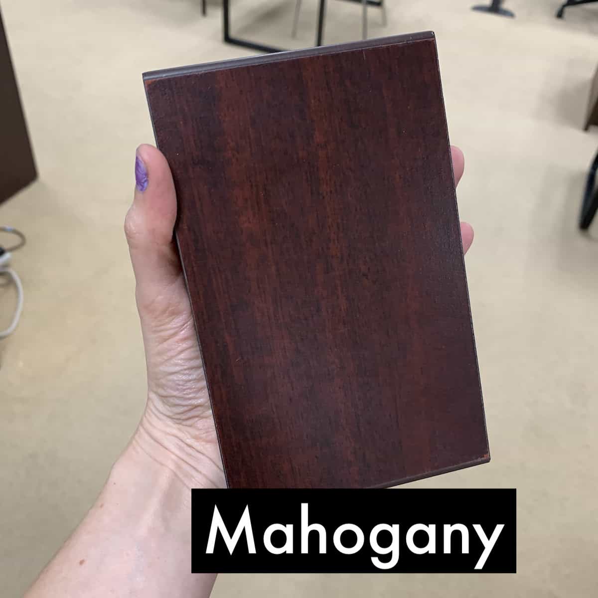 hand holding up an mahogany finish block