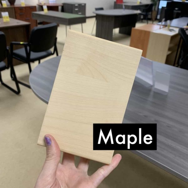 hand holding up an maple finish block