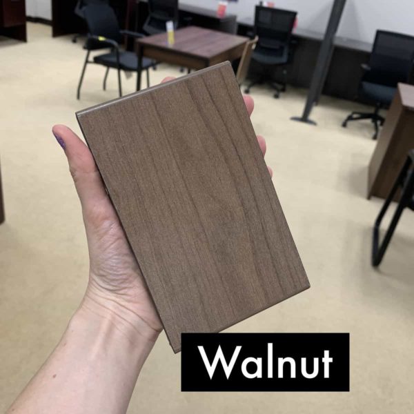 hand holding up an walnut finish block
