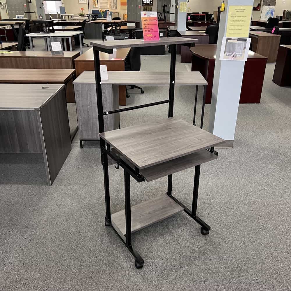 grey and black rolling computer cart, small and tall, with shelf above and below