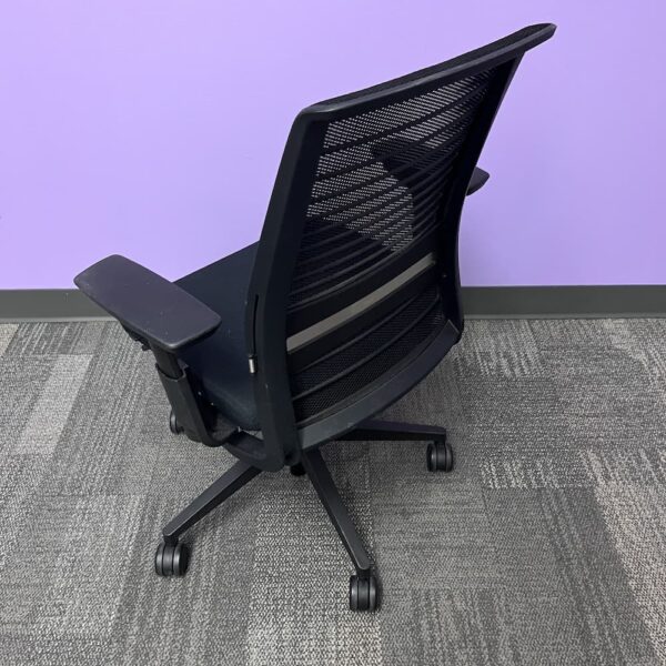 black upholstered seat and mesh back steelcase think task chair used office furniture
