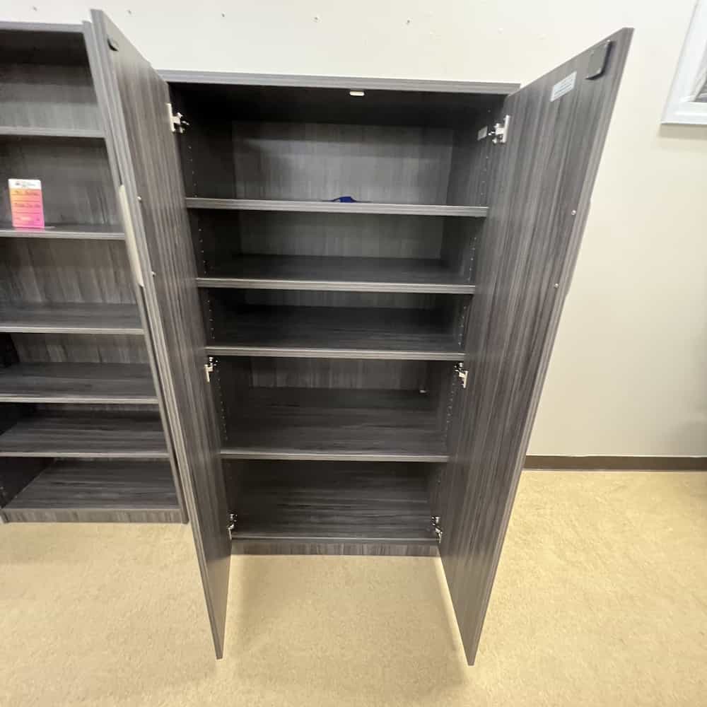 66" tall storage cabinet with doors and shelves inside, grey laminate with silver pulls, doors open