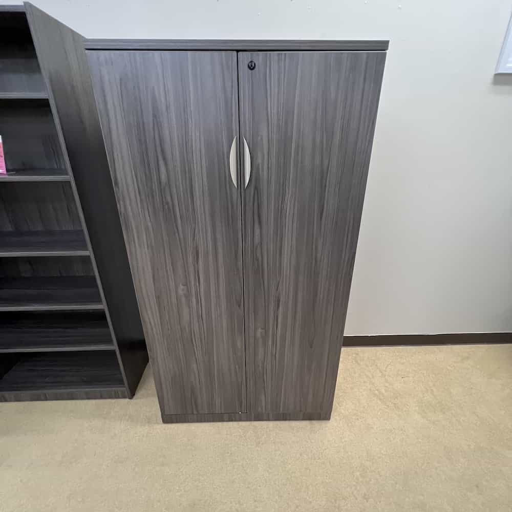 66" tall storage cabinet with doors and shelves inside, grey laminate with silver pulls