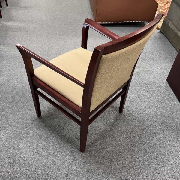 tan upholstered guest chair with mahogany veneer wood frame and arms, back