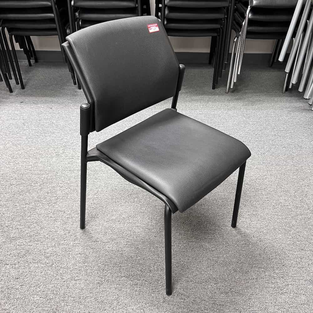 black pebble vinyl seat and back on black stacking chairs, no arms, front