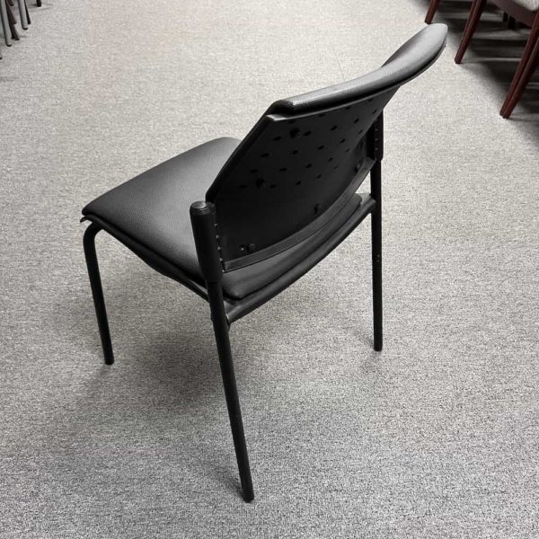black pebble vinyl seat and back on black stacking chairs, no arms