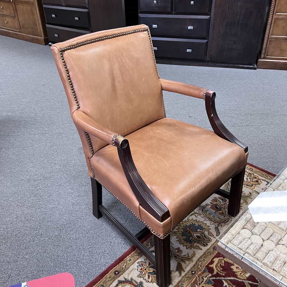 light brown camel leather arm chairs with gold nail heads rivets front side