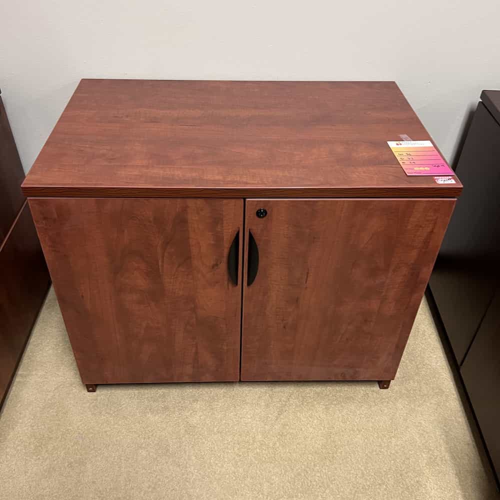 cherry cabinet with doors and black handles
