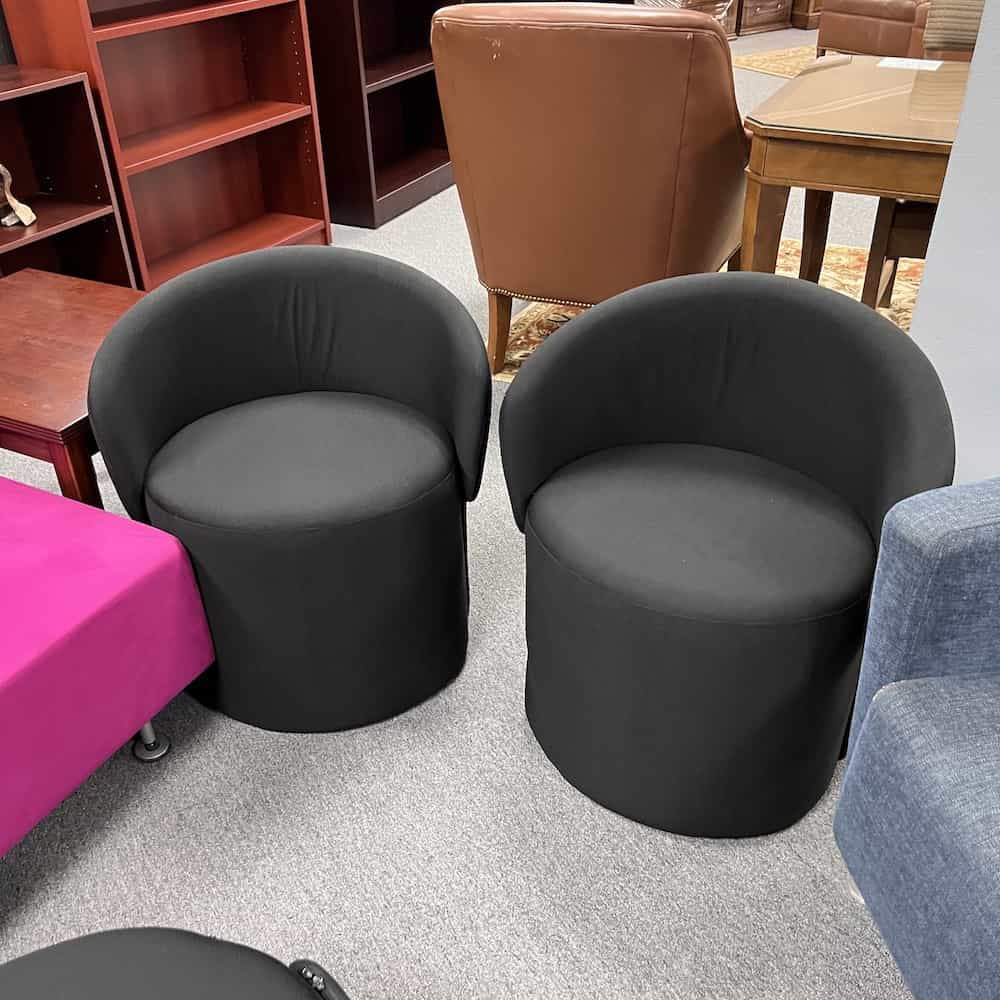 black ottoman that has a back rest that flips up and down depending on use - pictured up, front side
