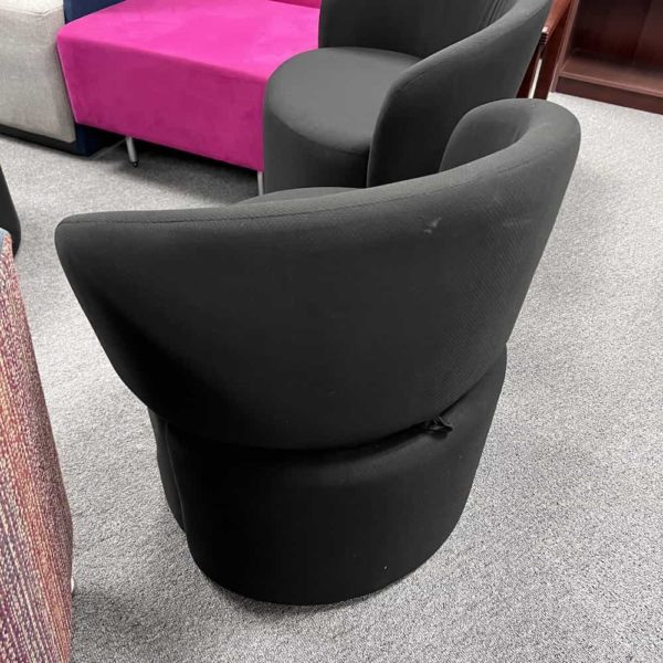 black ottoman that has a back rest that flips up and down depending on use - pictured up, back side
