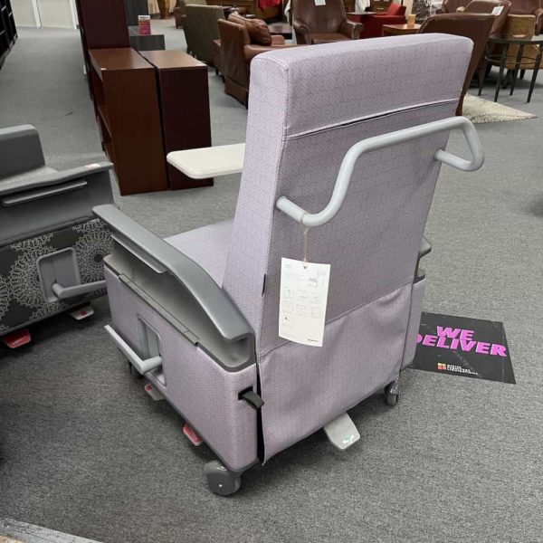 light purple chair with boxy back and grey plastic arms, white fold down table on right side, back view of push bar