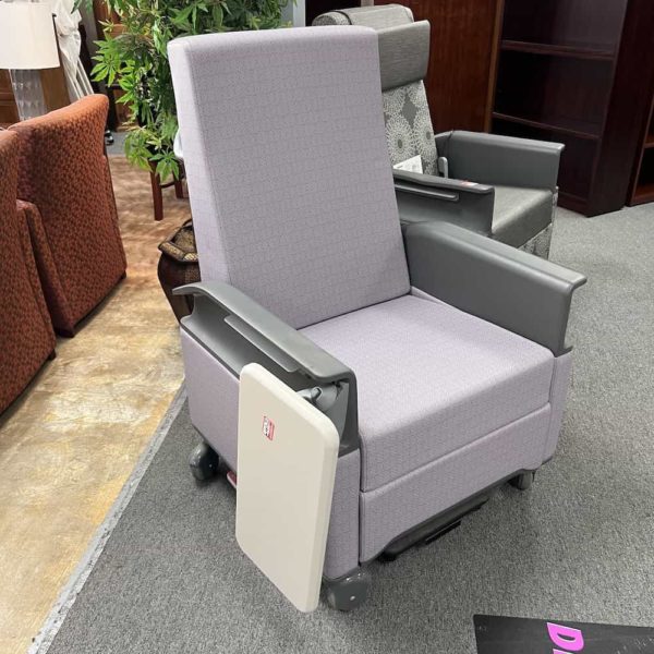 light purple chair with boxy back and grey plastic arms, white fold down table on right side