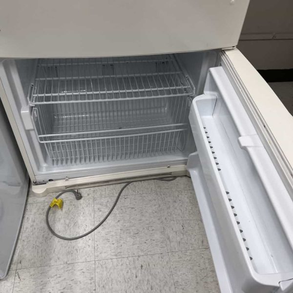 almond fridge freezer door open, white wire shelves