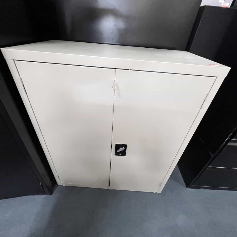 light tan metal boxy storage cabinet with 2 doors