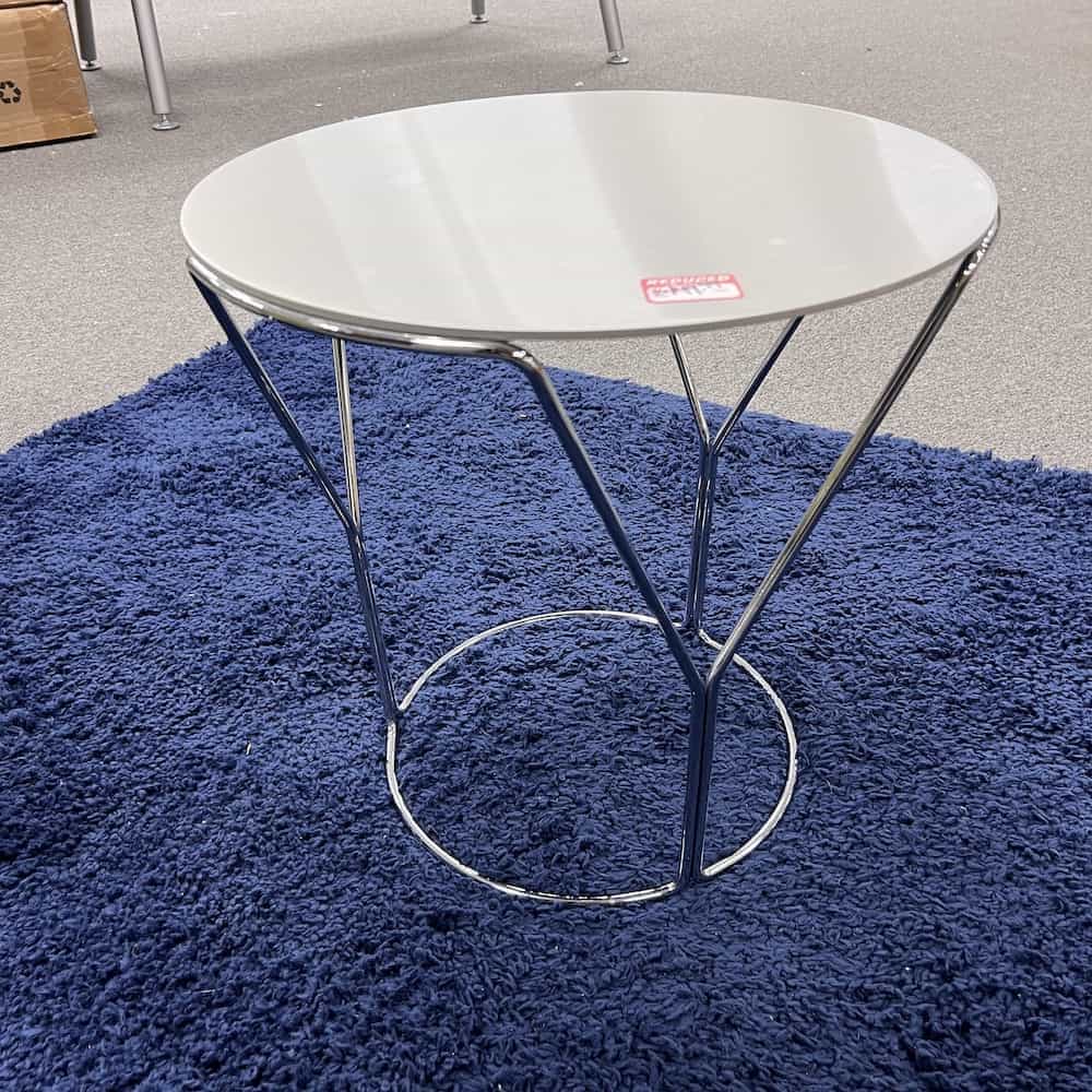 modern side table with three legs connected to a circle at the bottom