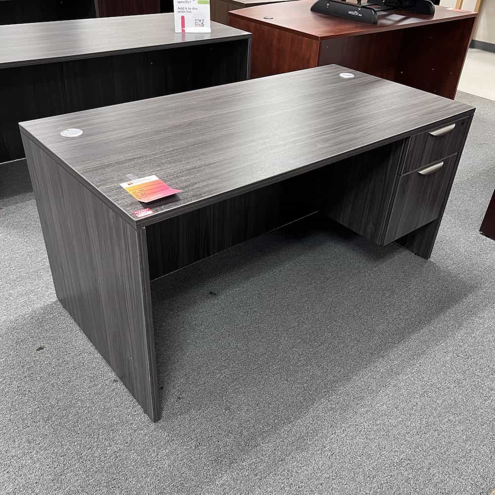 grey desk with one hanging file with silver handles