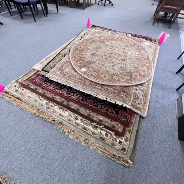 rugs on the floor, stacked
