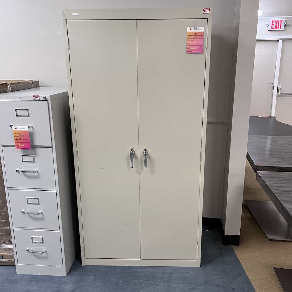 tan metal 2 door storage cabinet with two silver handles