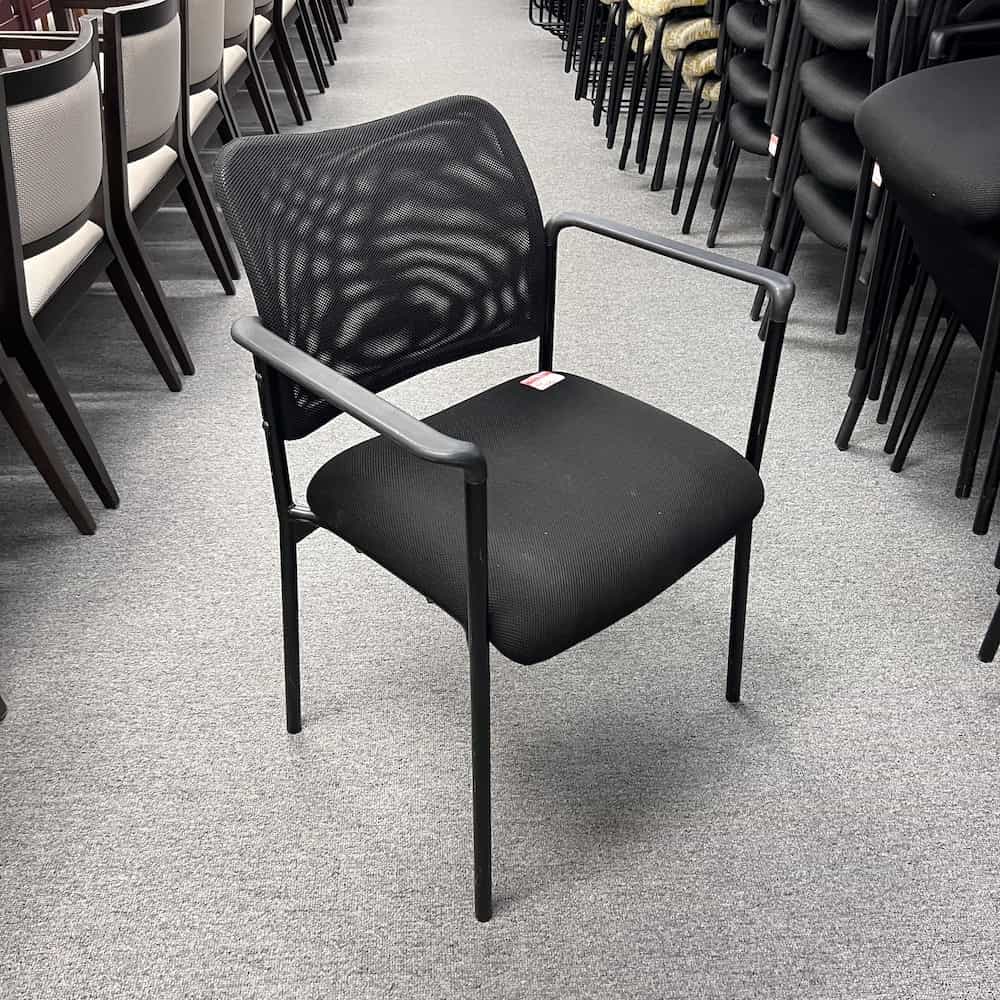 black mesh back stacking chair with arm rests