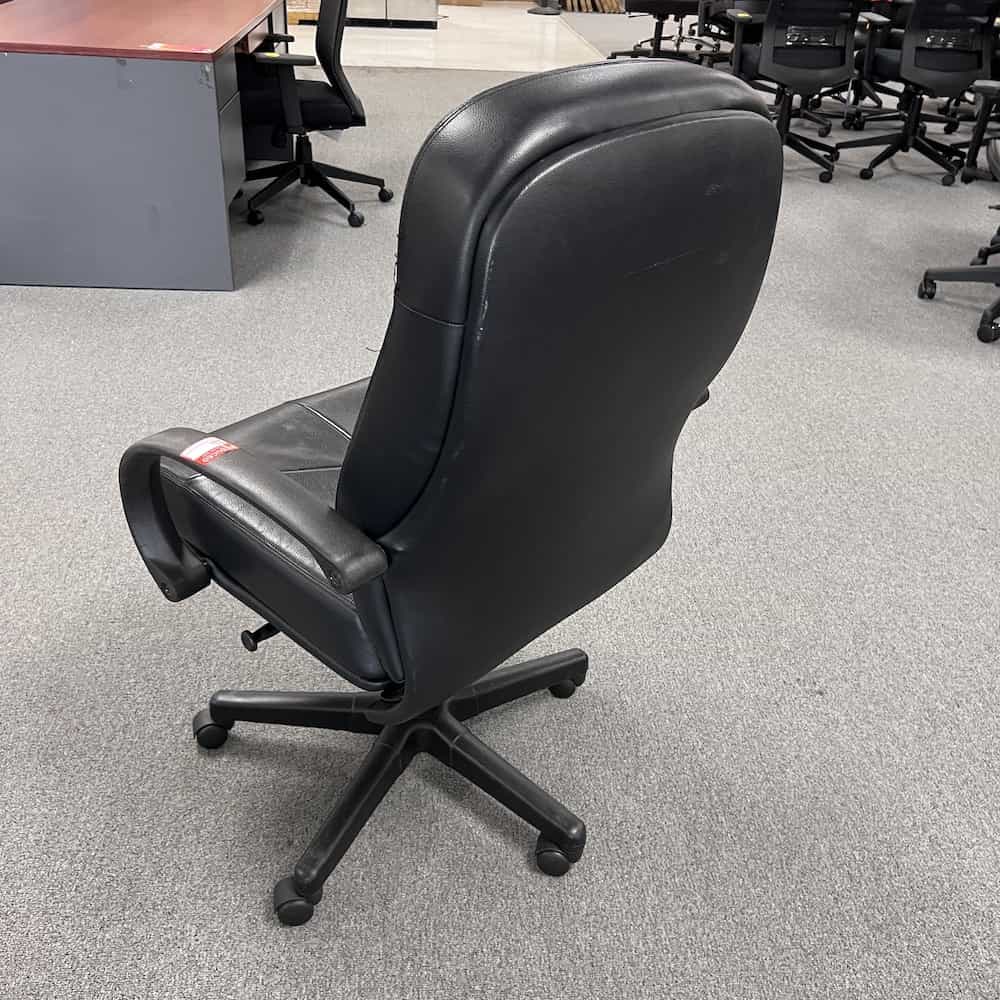 black vinyl chair, conference with fixed arms and plush look