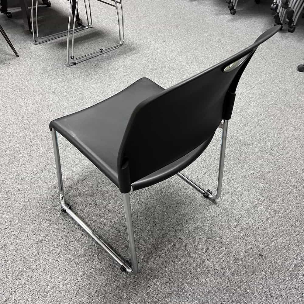 black plastic and chrome stacking chair