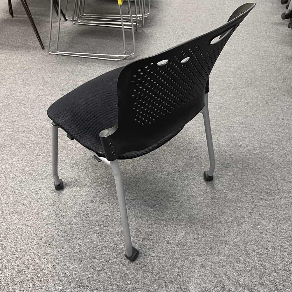 black plastic perforated back rolling stacking chair