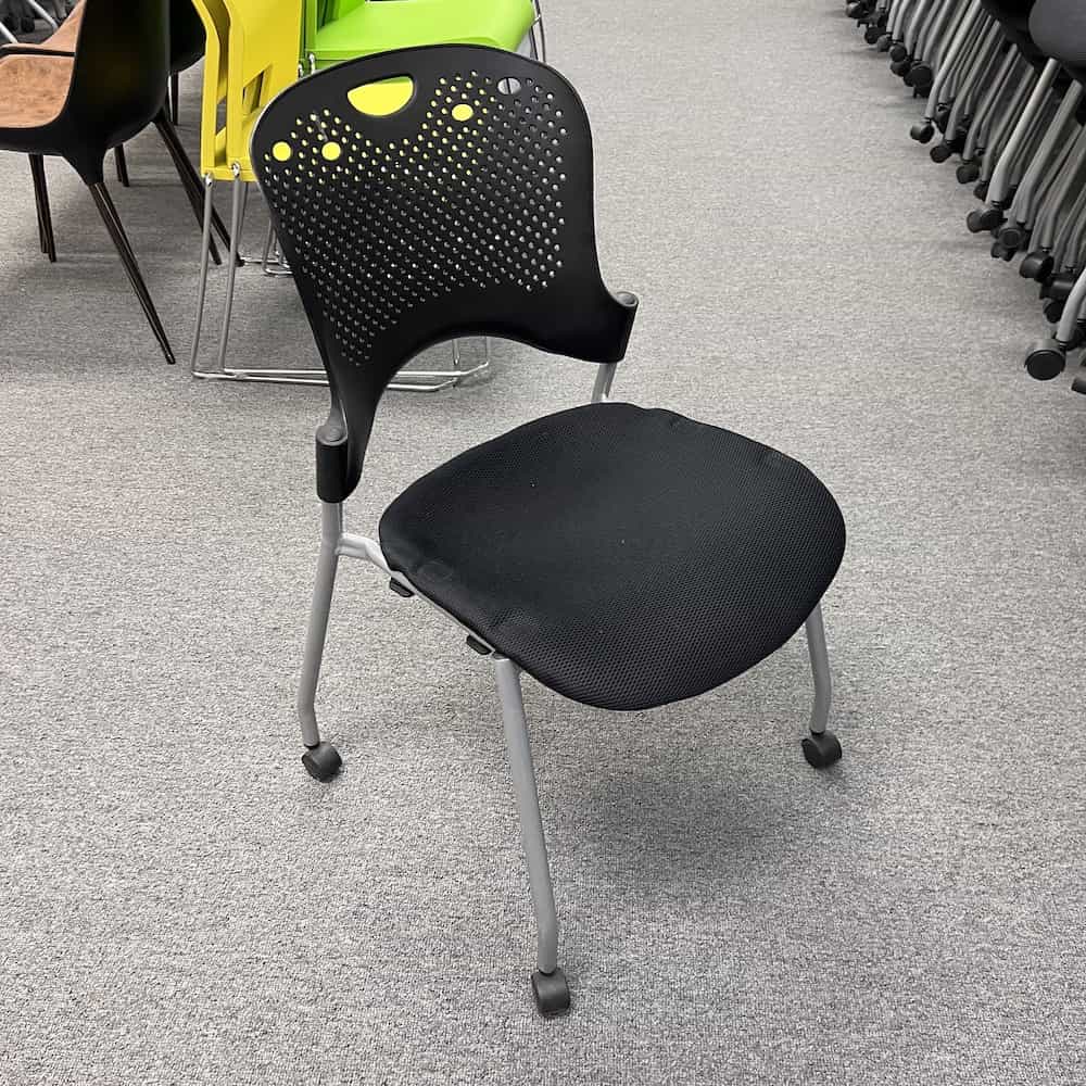 black plastic perforated back rolling stacking chair