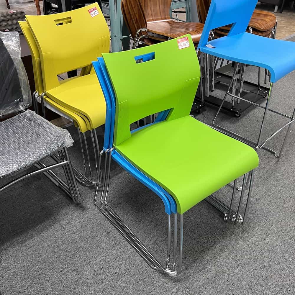 yellow, green, and blue stacking plastic chairs with chrome legs