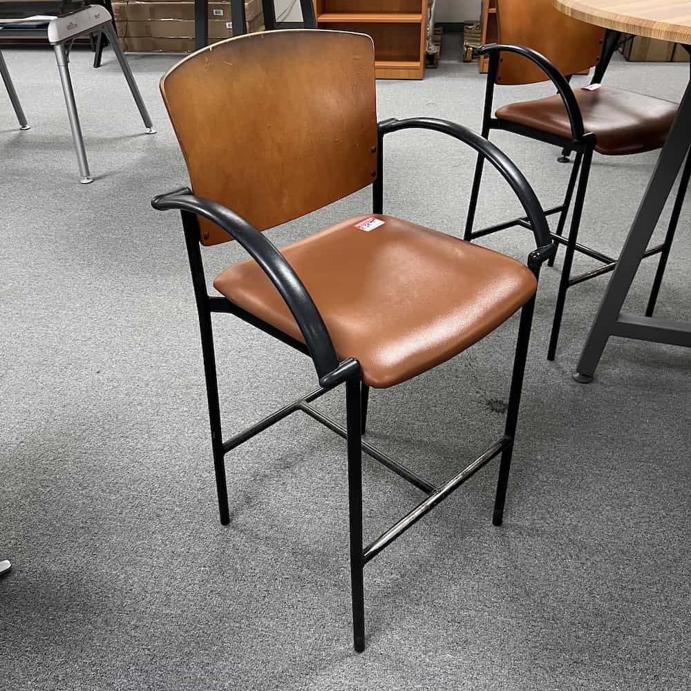 tan and black bar height stool with wood back and vinyl seat