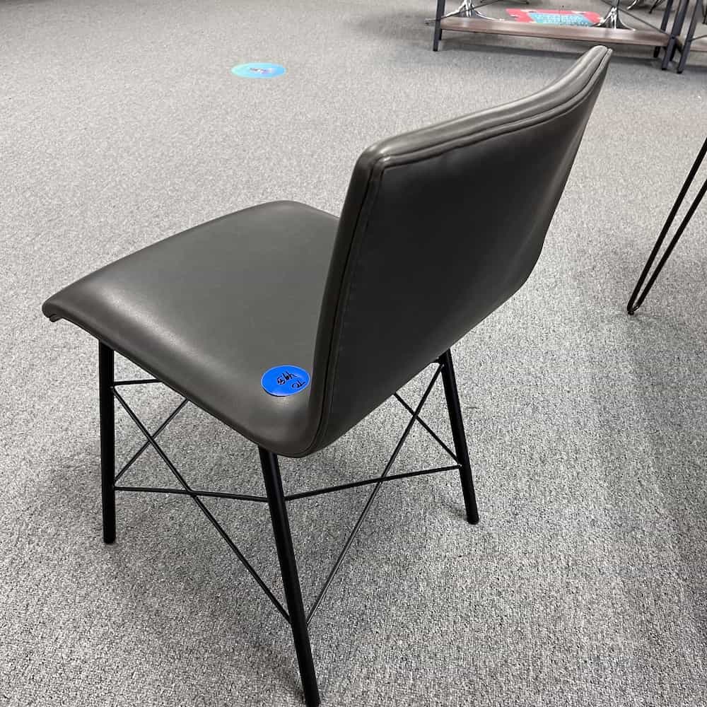 grey vinyl modern chair with criss cross metal base, no arms