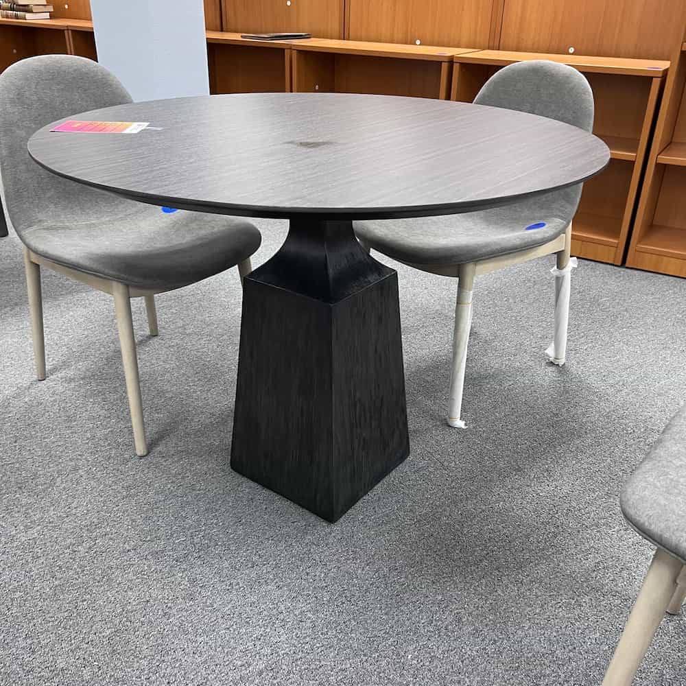 dark grey round table with pedestal base