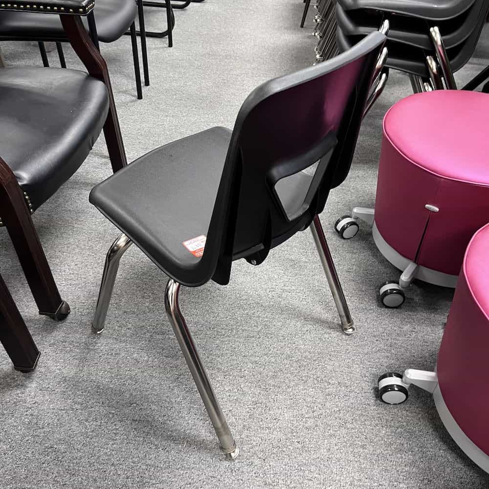 black plastic student seat stacking with chrome legs and triangle opening in back