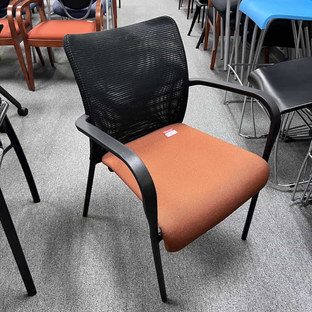 OFS stacking orange seat mesh back chair
