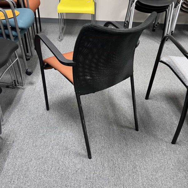 OFS stacking orange seat mesh back chair