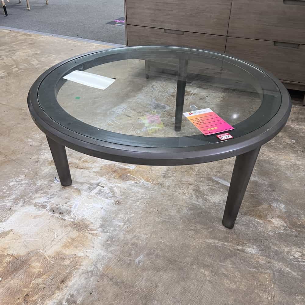 round taupe and glass coffee table with three legs