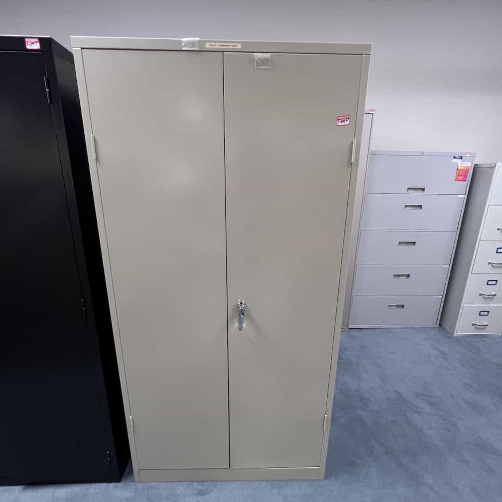 tan metal 2 door storage cabinet with one silver handle on right door