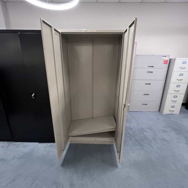 tan metal 2 door storage cabinet with one silver handle on right door, open