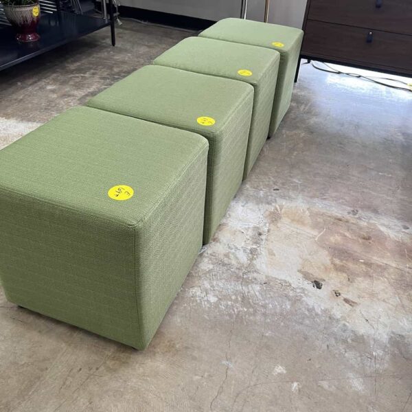 green upholstered square ottomans, in a row like a bench