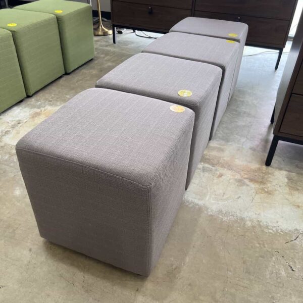 taupe upholstery square ottomans, in a row like a bench