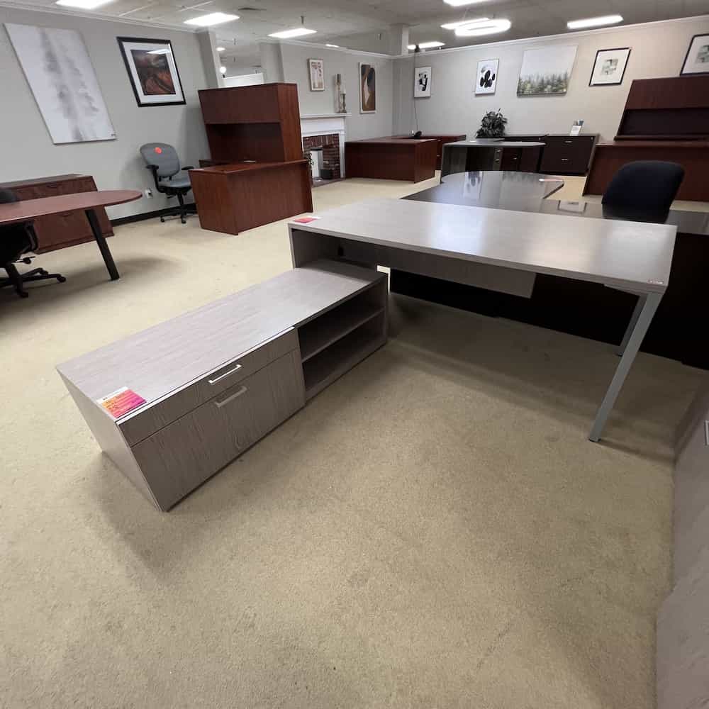 weathered grey taupe woodgrain laminate with silver pulls. table desk with credenza and one lateral file