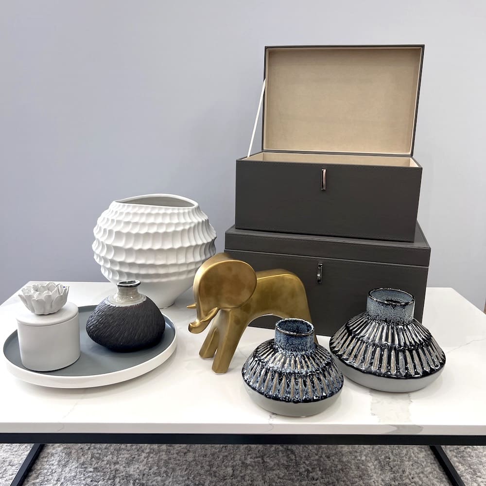 nine piece decor set with grey nesting boxes, gold elephant, white and grey vases
