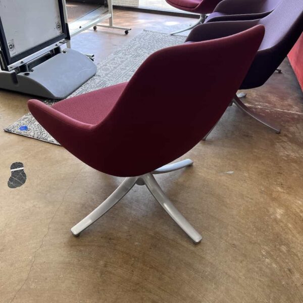 wine red modern swivel chair with silver base, back view