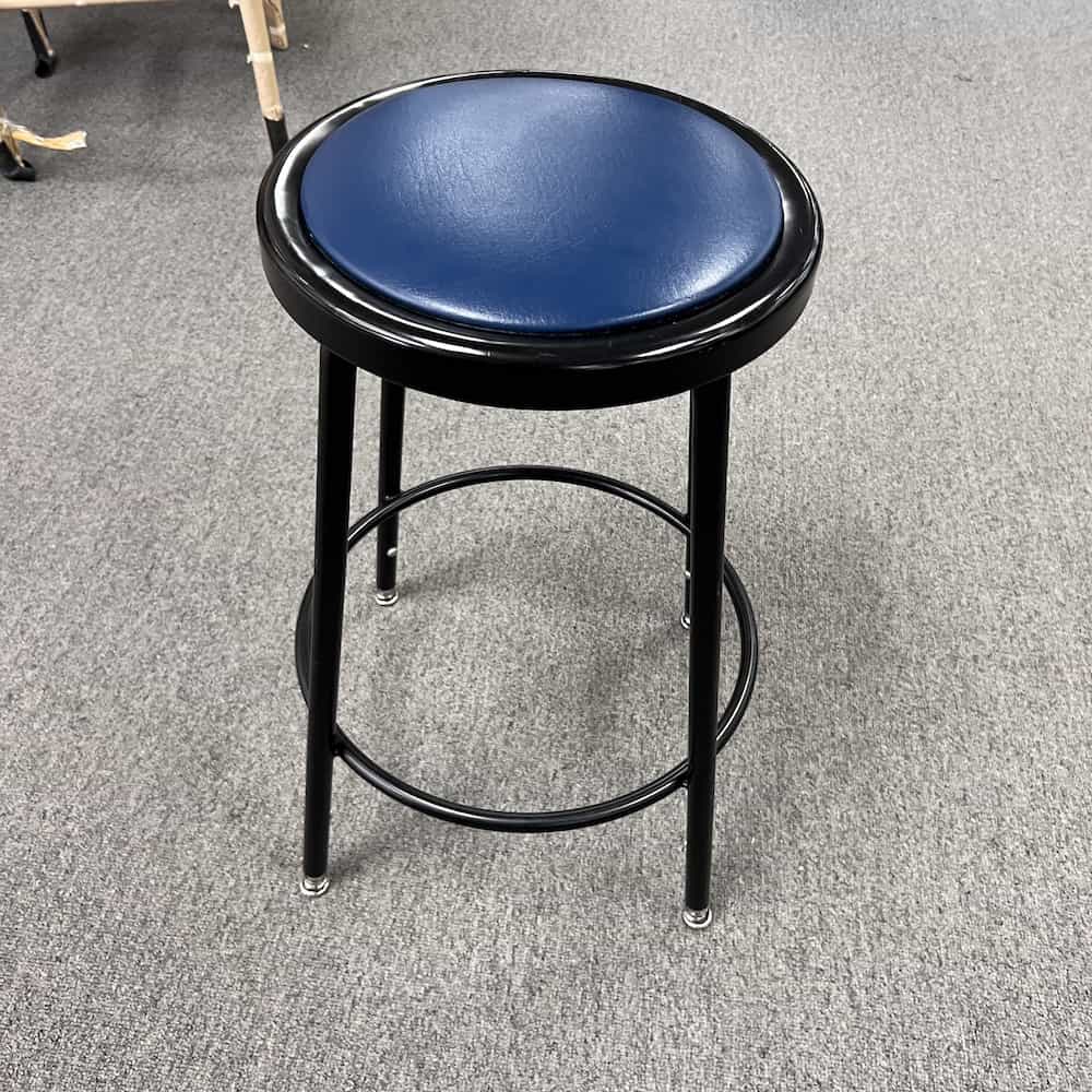 black metal stool with blue vinyl cushion top