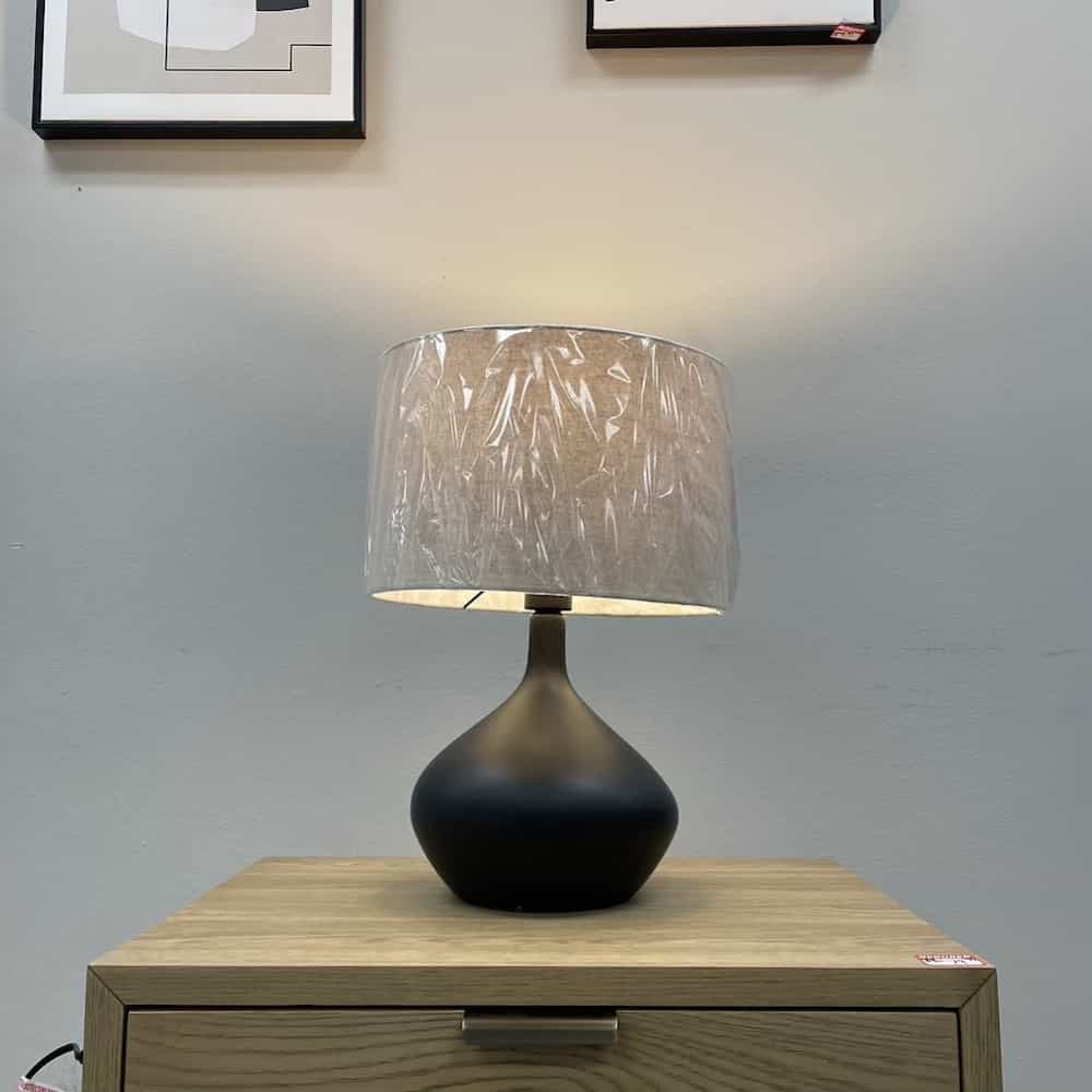 lamp with black teardrop base and natural linen look lamp shade