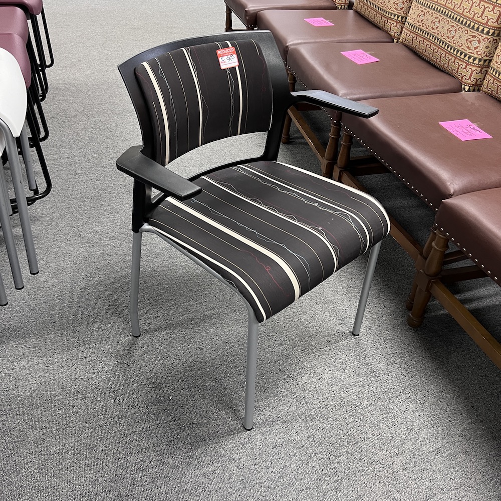 brown stripes and squiggles upholstery seat and back, black frame, silver metal legs