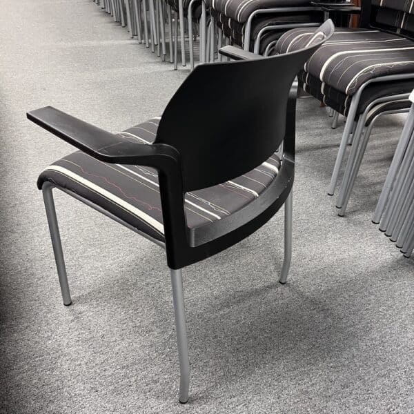 brown stripes and squiggles upholstery seat and back, black frame, silver metal legs, back view