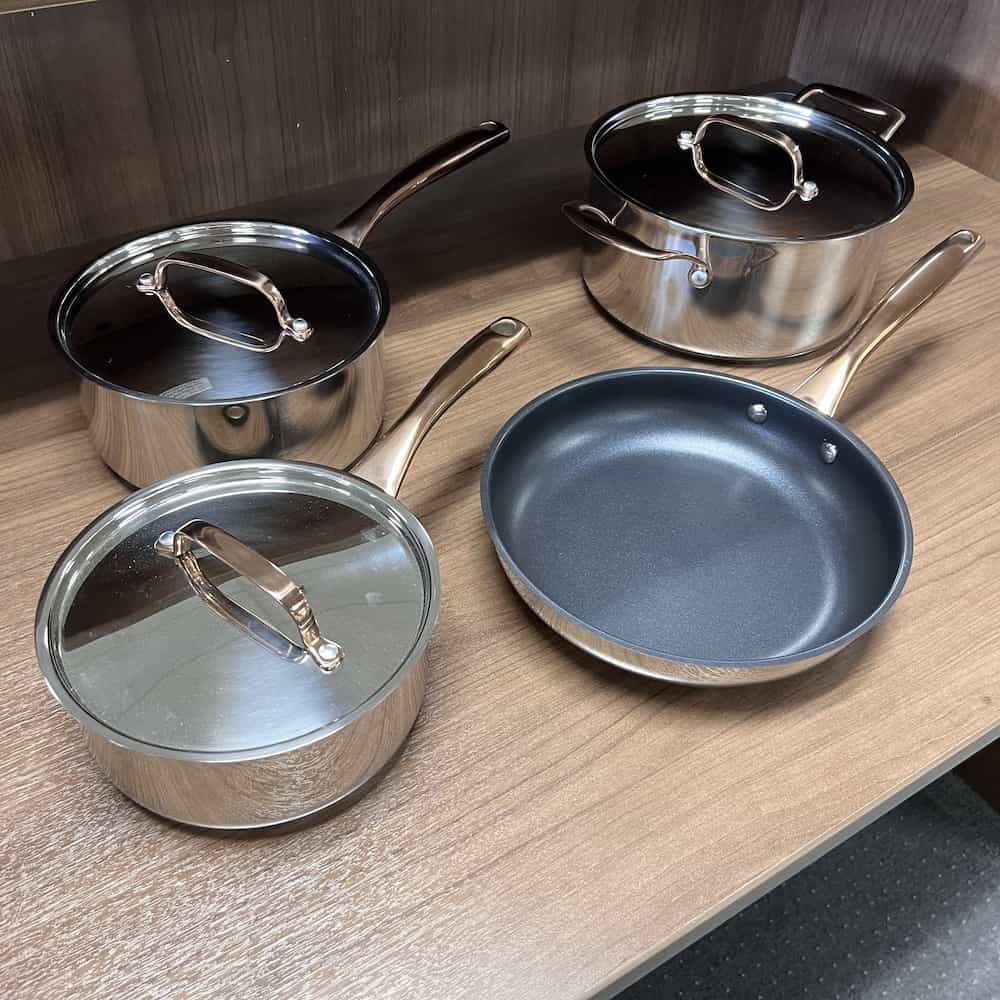 cookware set with a small an medium saucepan, frypan, and soup pot