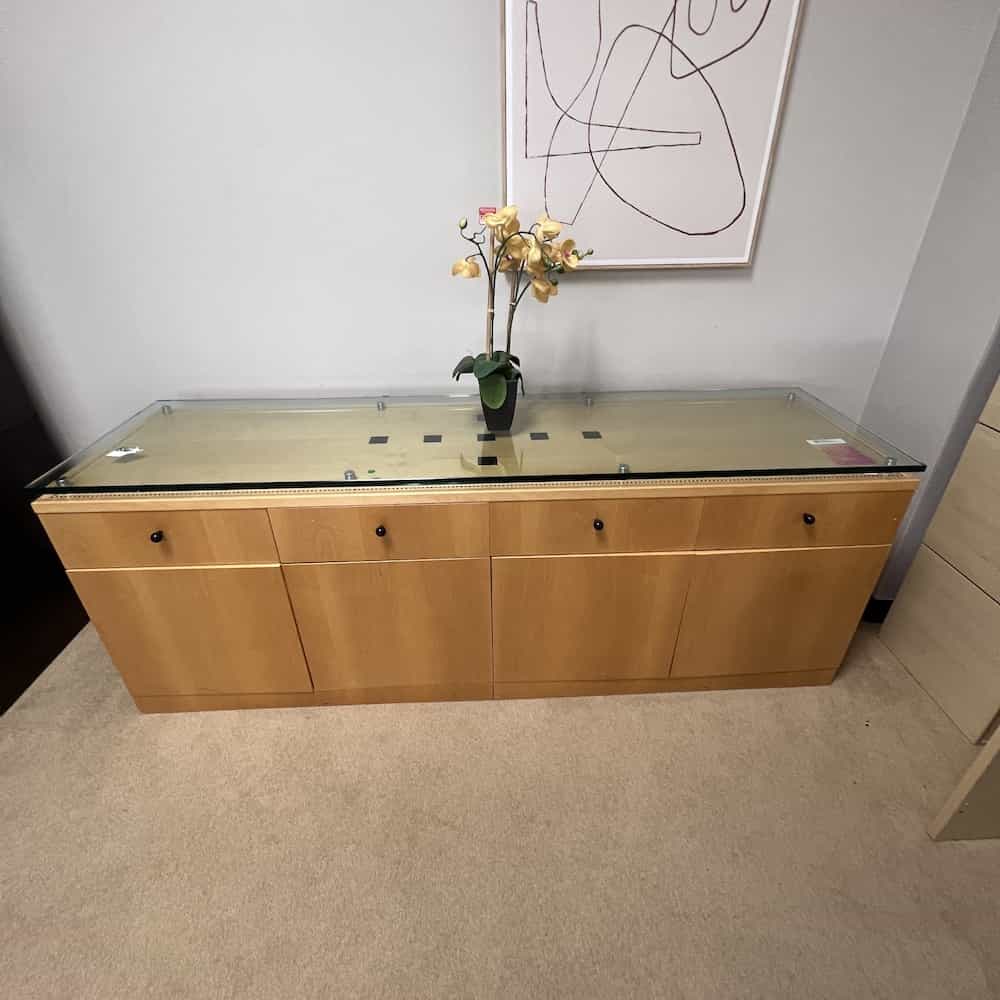maple credenza storage cabinet with 4 doors, 4 drawers, black inlay, black pulls, glass float on top