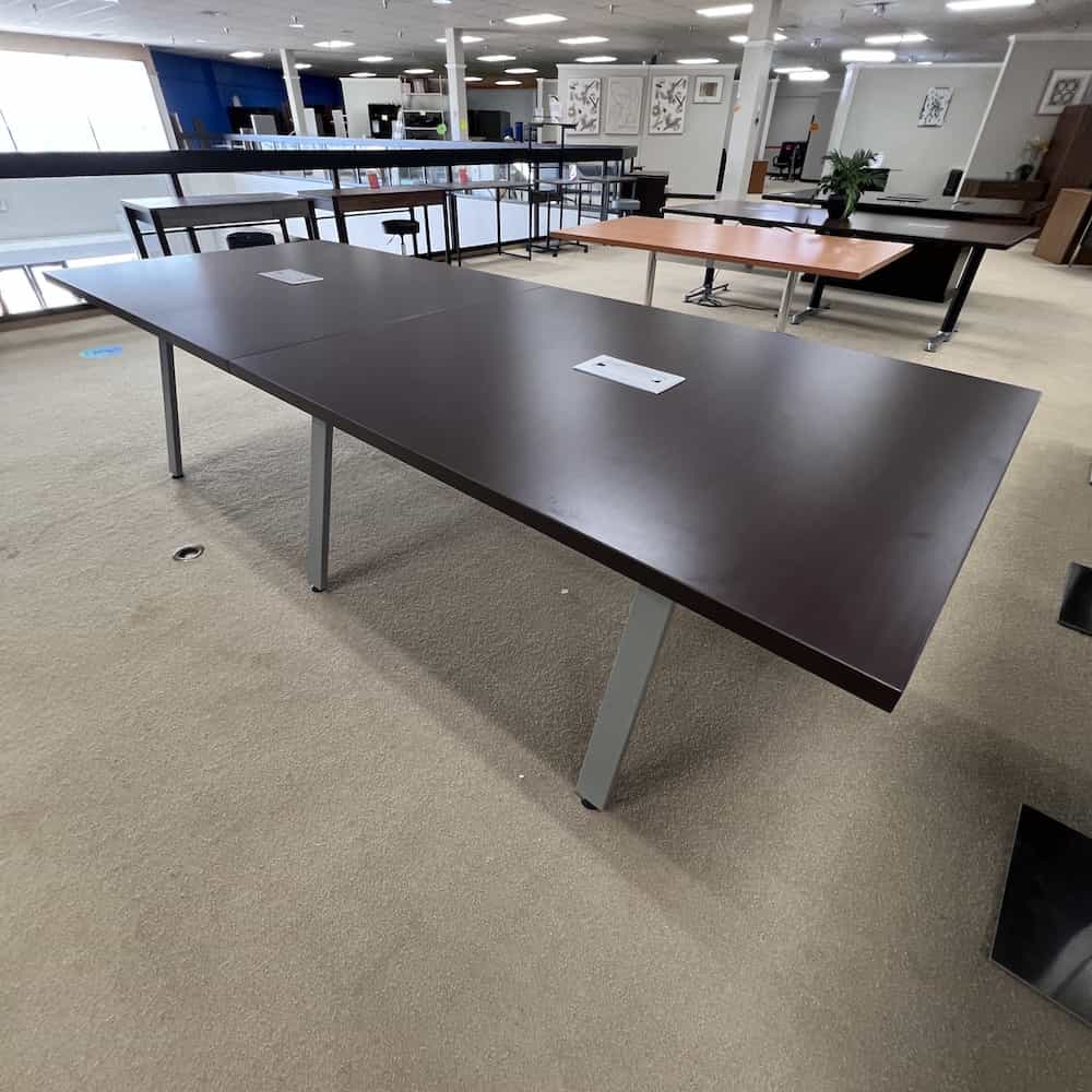 espresso rectangle conference table with angled silver legs, 3 sets of legs, silver chord port holes